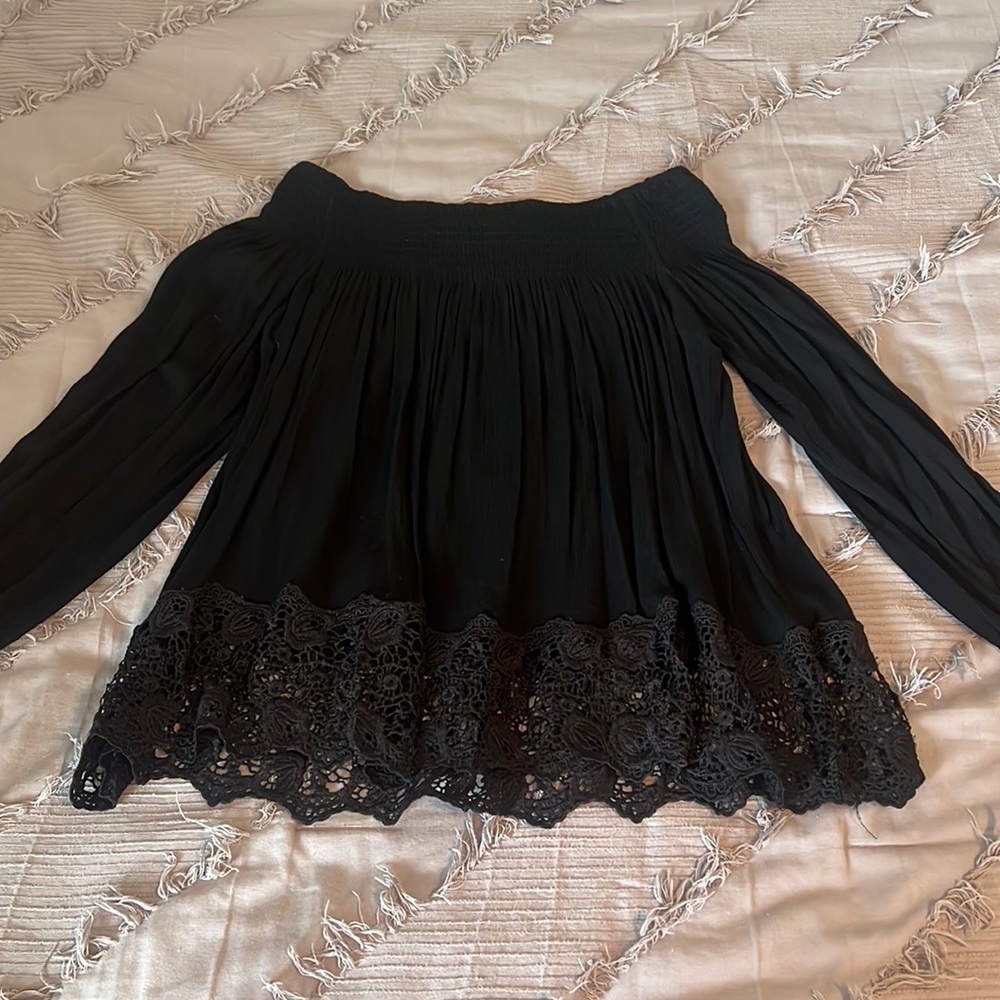 Long sleeved, off the shoulders, black top.